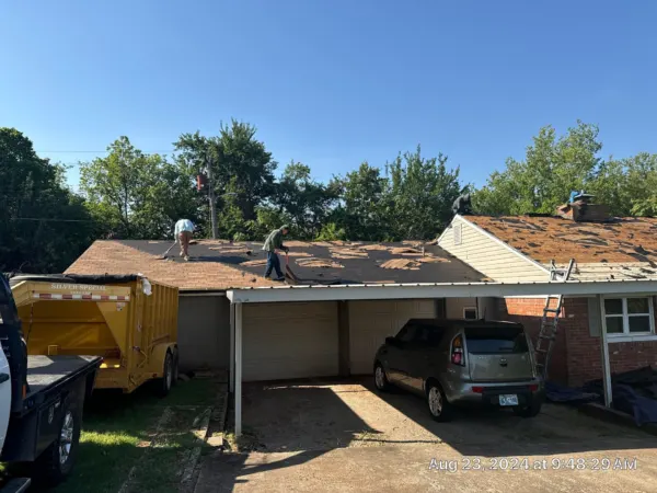 Dump trailer parked at the home for roof tear-off debris