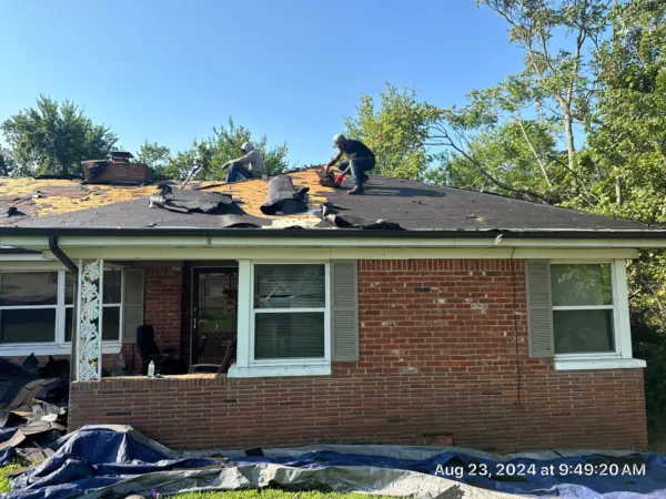 Tarps protecting landscaping while the old roof is removed