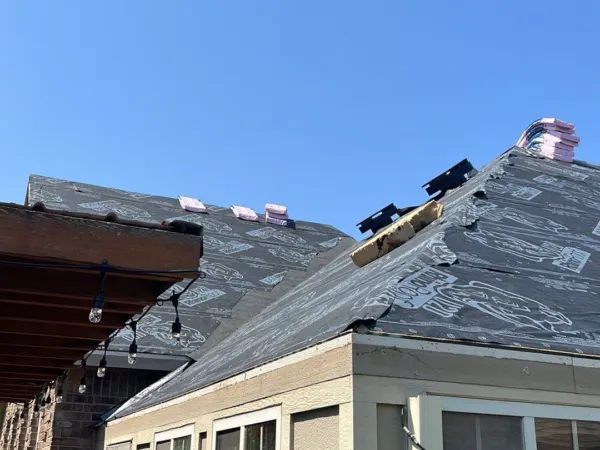 Back of a brick home during the roof replacement