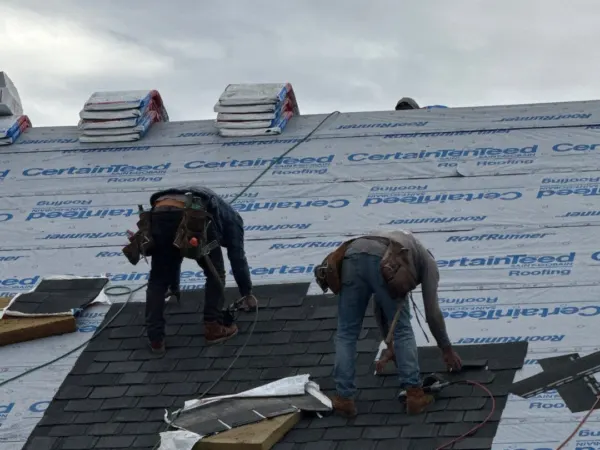 Roofers installing shingles above the ATM drive-through
