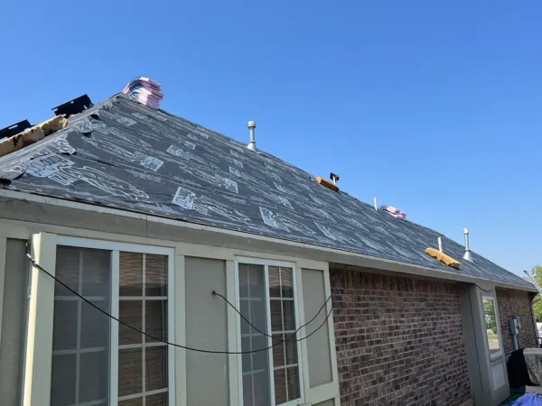 Underlayment and new shingles on a brick home roof