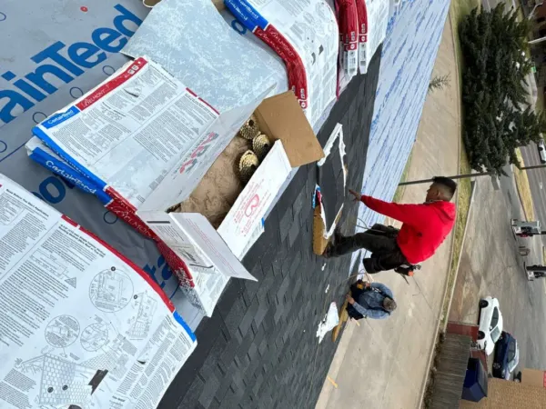 Underlayment and shingles staged on the commercial roof slope