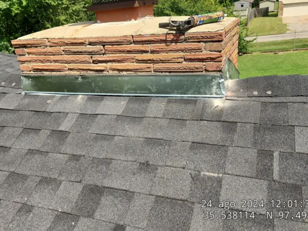 Chimney area before new shingles and flashing were installed