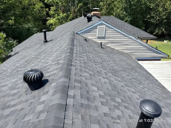 Roof vents and pipe flashing on the new dark gray shingle roof