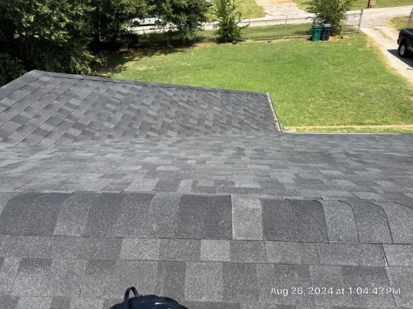 Completed dark gray architectural shingle roof surface