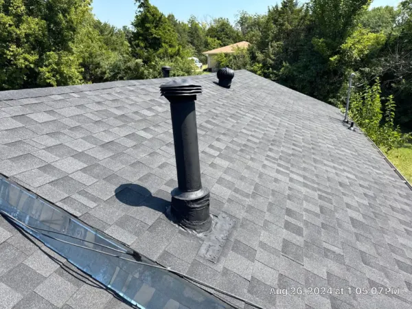 Close-up of a new plumbing vent boot on the finished roof