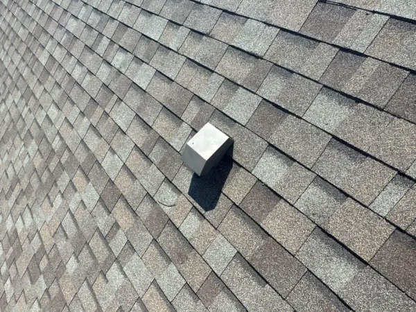 Close-up of new architectural shingles with a roof vent