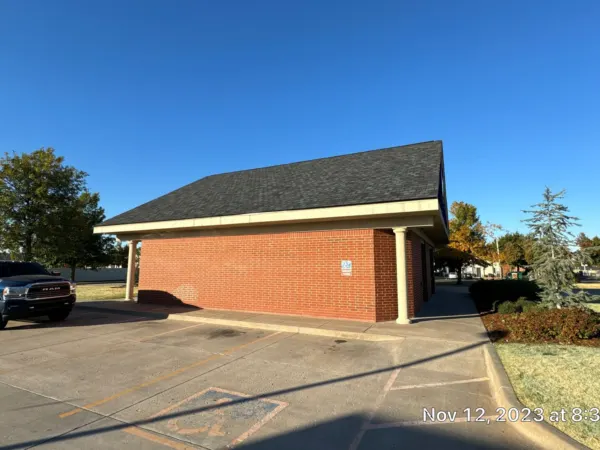 Finished new roof on the side of the brick commercial building