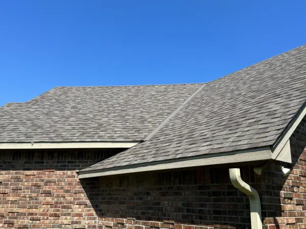 Brick home with its finished Driftwood shingle roof