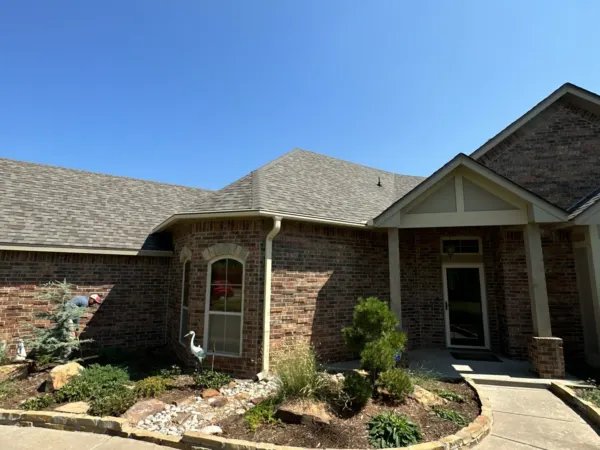 Front of the brick home after a complete roof replacement