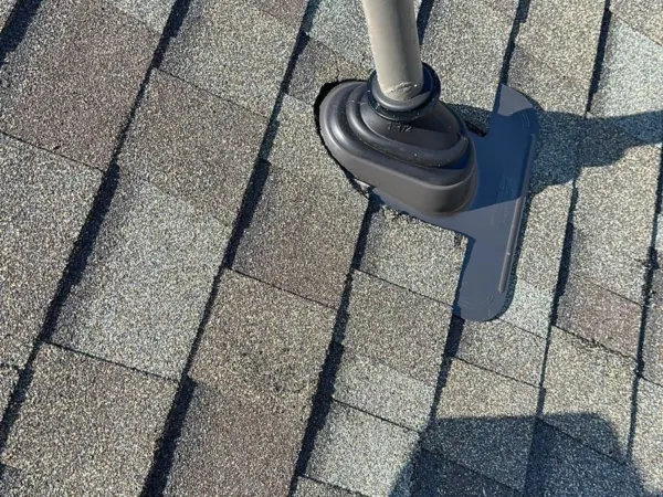 New plumbing vent flashing on the shingle roof