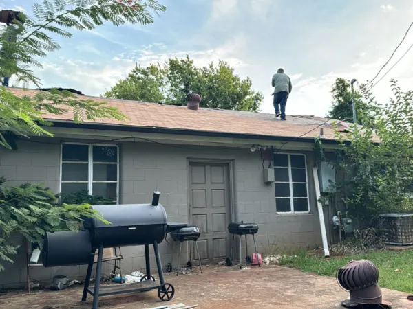 Side of the ranch home before the roof replacement began