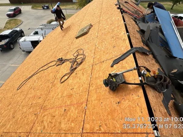 New roof decking going down during the commercial roof replacement