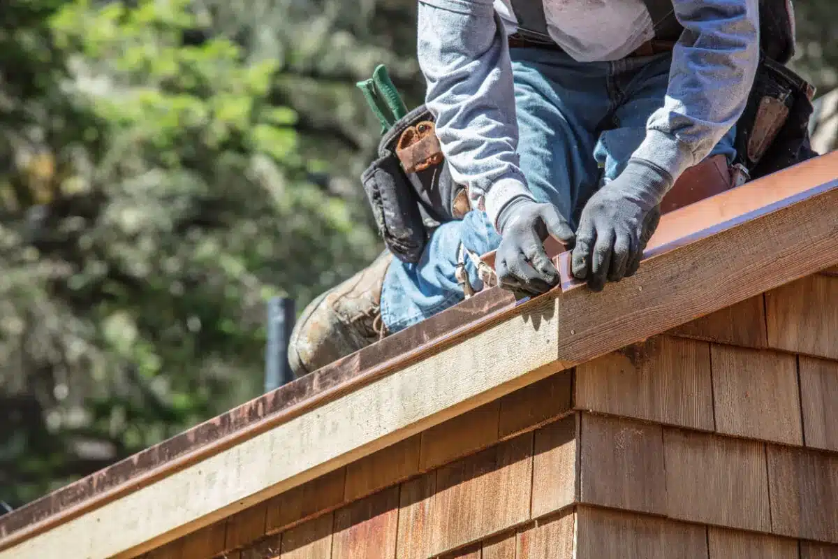 A professional installs copper drip edge during an Edmond OK Roof Flashing Repair project completed by Roof One.